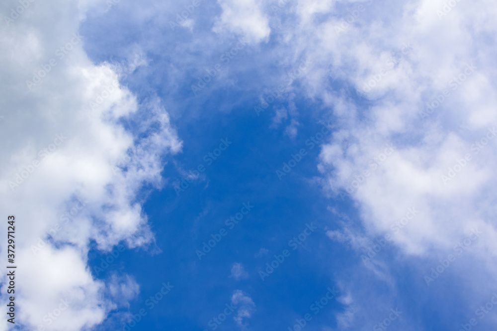 Obraz premium White clouds and blue sky. Blurred clouds background.