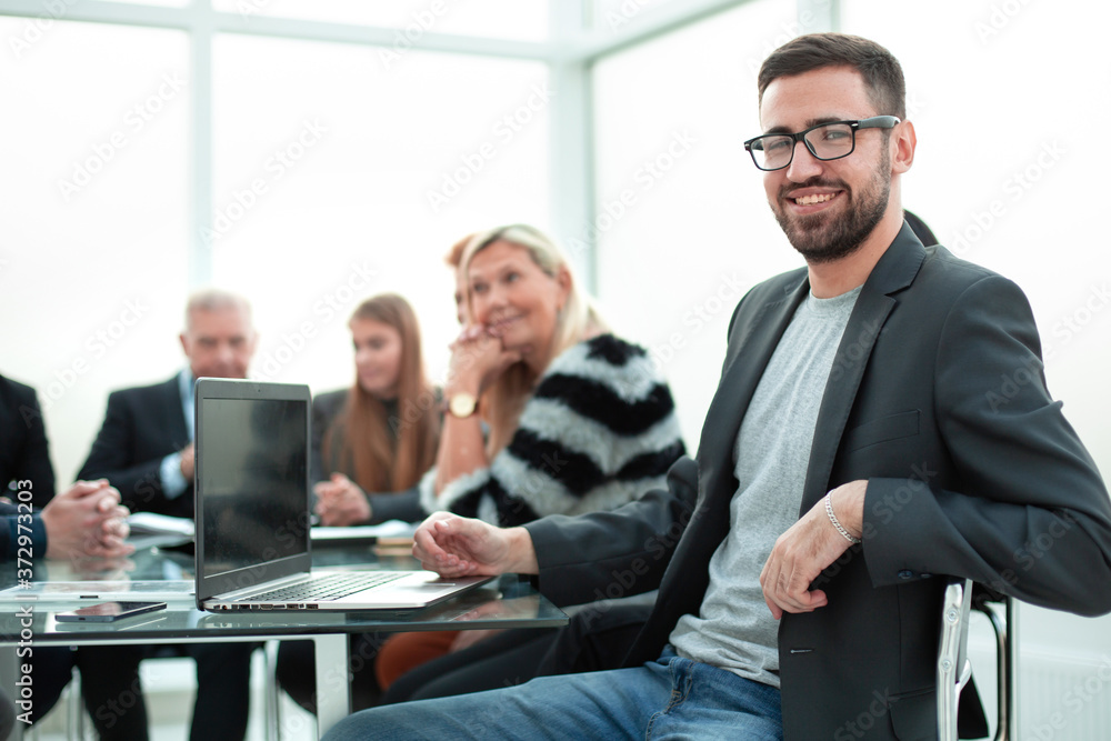 young business man looking at the camera in the office. business concept. young business man looking at the camera in the office. business concept.
