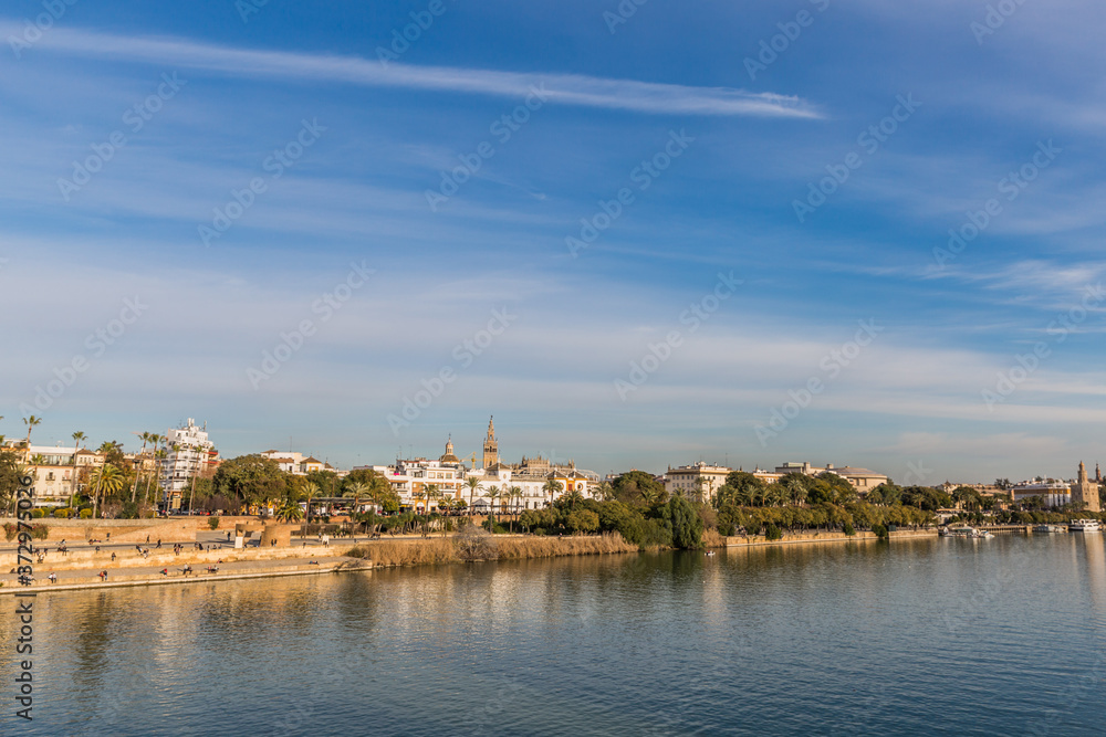 Guadalquivir river and a part of the city of Seville Spain on a wonderful sunny day and a blue sky with few white clouds
