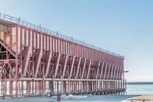 Steel structure of ore quay of Almeria or loading bay the Alquife, beautiful sunny day with a blue sky on the Cable Ingles or English cable in the municipality of Andalucia, Spain