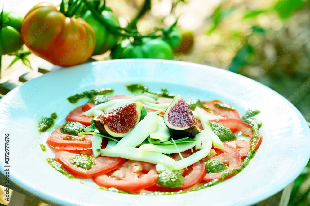 tomato carpaccio with figs served in a ecological vegetable garden tomato carpaccio with figs served in a ecological vegetable garden