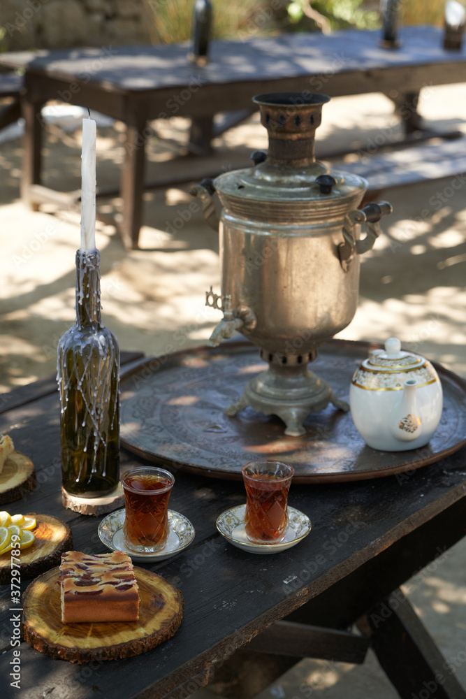 Breakfast table with apple pie, tea glass, outdoors. Homemade Apple Pie Breakfast table with apple pie, tea glass, outdoors. Homemade Apple Pie
