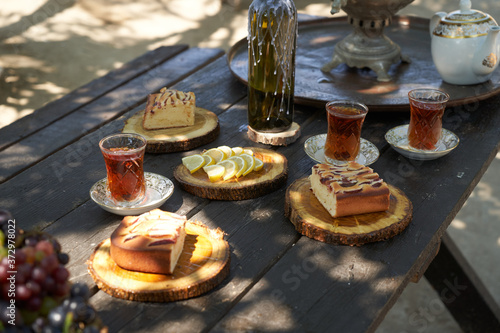 Breakfast table with apple pie, tea glass, outdoors. Homemade Apple Pie