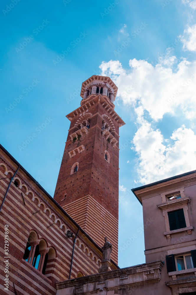 Red brick medieval Lamberti tower in Verona, Italy.