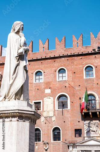 Statue of Dante located in front of historical red brick building at Piazza dei Signori located in Verona, Northern Italy.