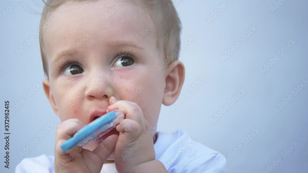 Cute baby drinks independently from a bottle. The child himself holds the bottle. Portrait of a kid. Health food. Healthy lifestyle. Baby food. Cute baby drinks independently from a bottle. The child himself holds the bottle. Portrait of a kid. Health food. Healthy lifestyle. Baby food.