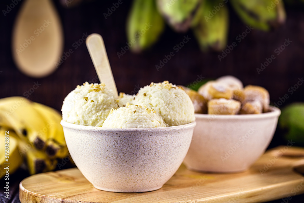vegan banana ice cream, made with frozen banana without added sugar or dairy. Dessert served in a biodegradable plastic pot. vegan banana ice cream, made with frozen banana without added sugar or dairy. Dessert served in a biodegradable plastic pot.