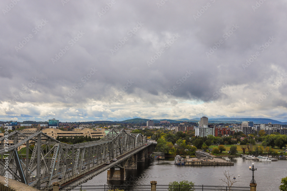 Parliament Hill, Ottawa, old bridge of Rideau canal in Autumn. Cloudy sky