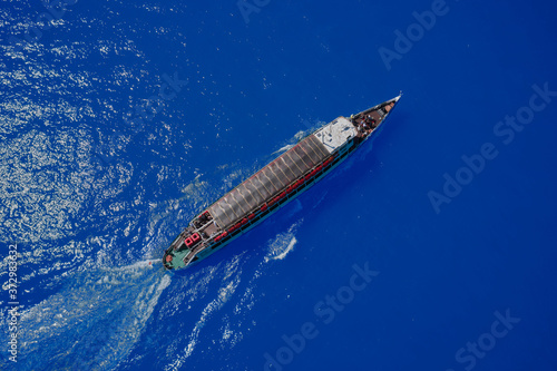 Pleasure ship in motion on blue water top view. Ship aerial view © Berg