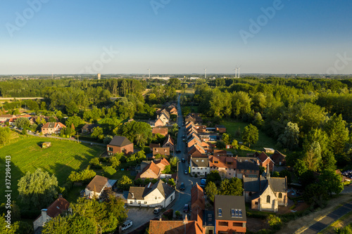 Aerial view of Vlassenbroek (in Baasrode), a small village on the shore of Scheldt river, on a warm summer evening