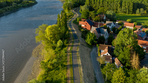 Aerial view of Vlassenbroek (in Baasrode), a small village on the shore of Scheldt river, on a warm summer evening photo