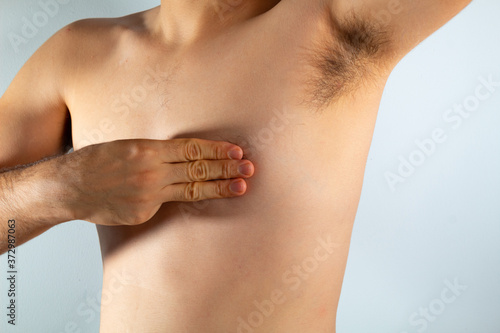 close up of a man's chest looking for signs of male breast cancer