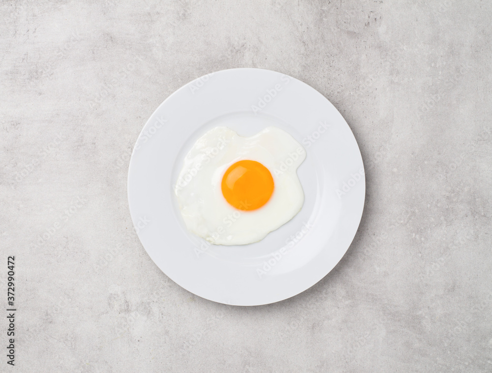 fried egg on gray concrete background fried egg on gray concrete background