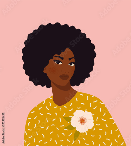 Beautiful black woman. Young african american. Portrait of young woman with beautiful face and hair. Side view. Isolated on a beige background.