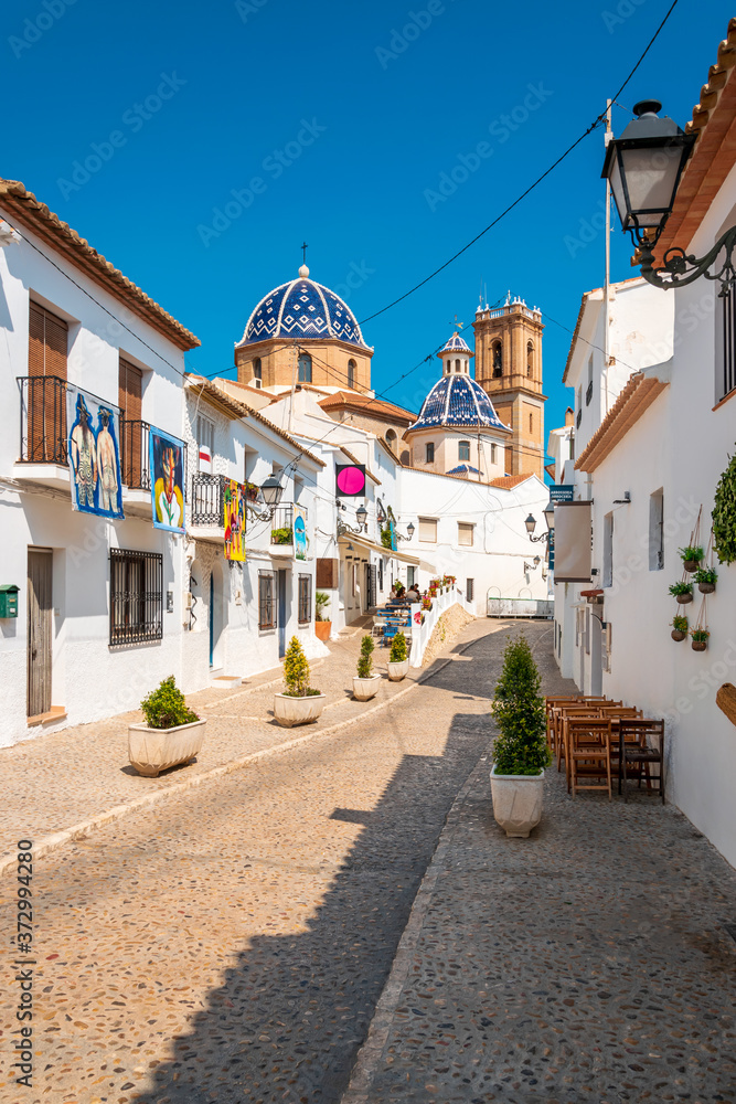 Iconic blue-and-white domed church in bohemian old town of Altea, Costa Blanca, Spain