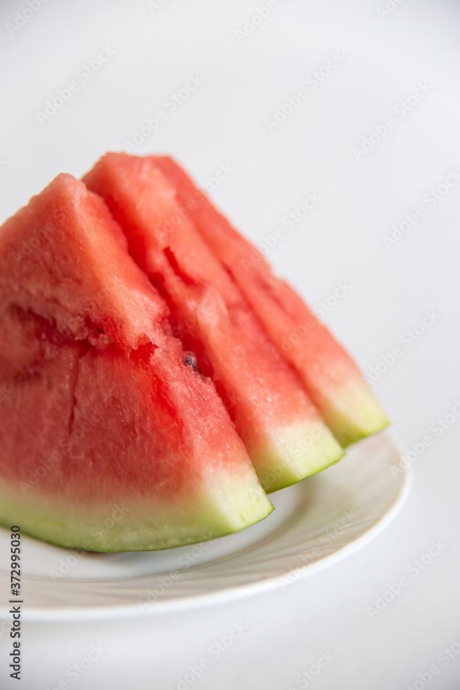 sliced watermelon on a plate isolated on white background sliced watermelon on a plate isolated on white background