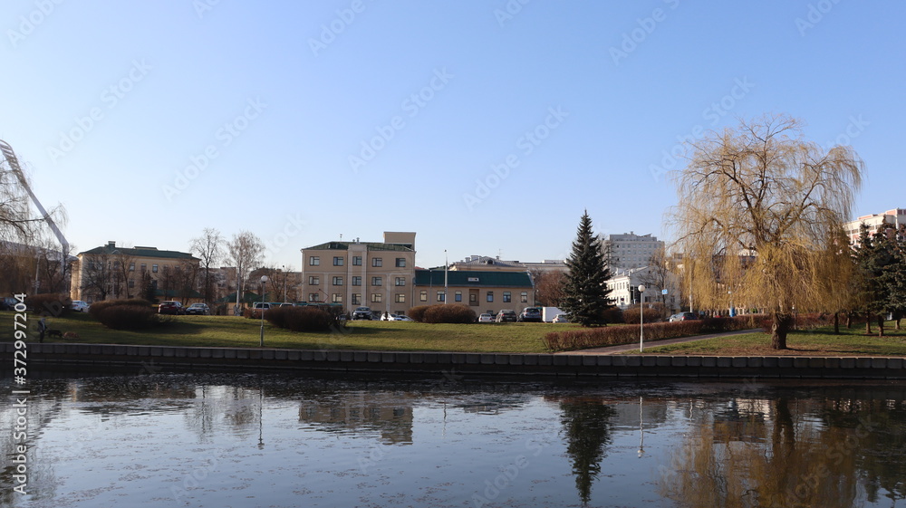 Fototapeta premium autumn MInsk central street with buildings and quayside