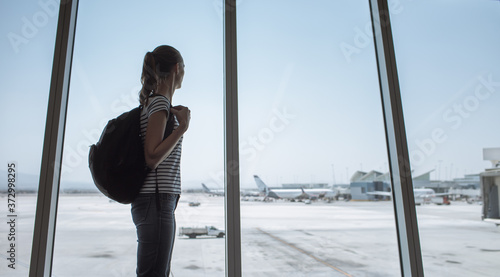 Female traveler at airport waiting to board airplane  © kieferpix