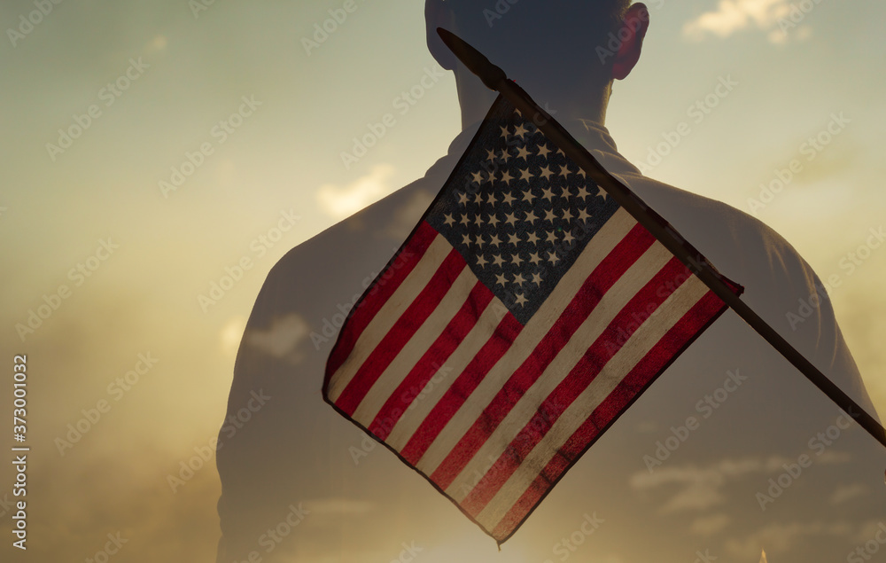 Man standing in front of USA flag. American hero concept. Man standing in front of USA flag. American hero concept.