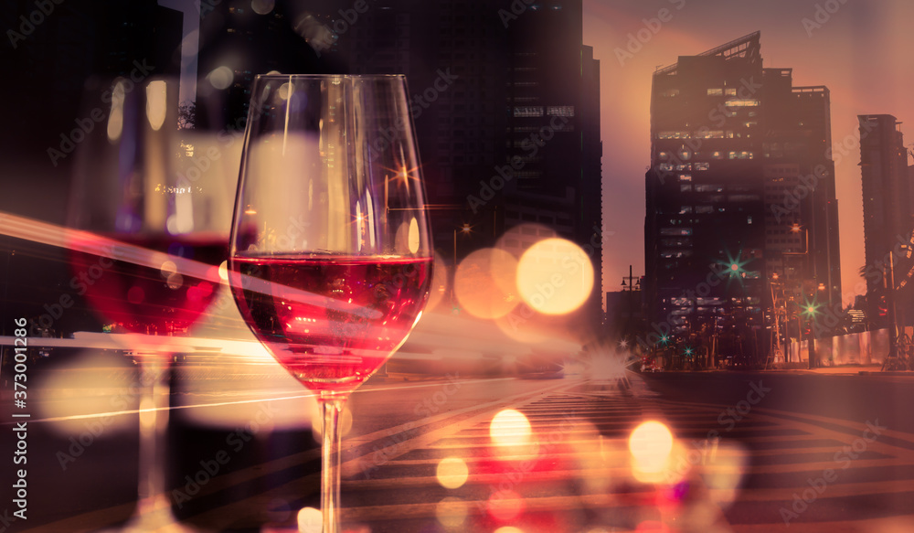 Fine dinning in the city concept. Wine glass and modern city background. 