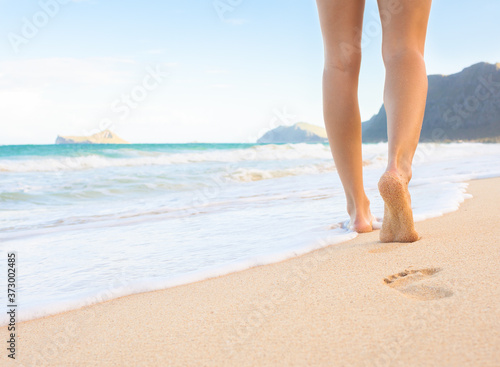 person walking on the beach location Oahu, Hawaii 