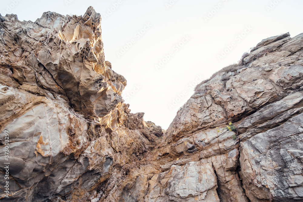 Rocky beach and turquoise water of Tirrenian sea in Baratti, Tuscany, Italy. Cliff Buca delle Fate. Tourism destination. Rocky beach and turquoise water of Tirrenian sea in Baratti, Tuscany, Italy. Cliff Buca delle Fate. Tourism destination.