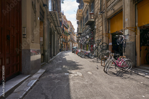 Sidestreet in Palermo Sicily with a bikeshop and typical life 