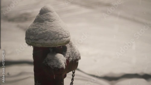 Red Fire Hydrant covered in thick snow during winter snow blizzard