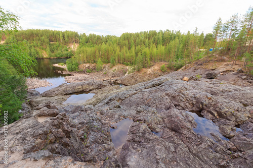 Palieozerskaya hydroelectric power plant and Suna river in Hirvas, Karelia region, Russia). Hydroelectric dam, reservoir, powerhouse, waterway, spillway gates. Girvas beautiful scandinavian landscape photo