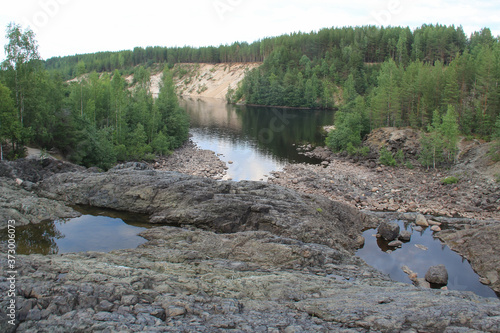 Palieozerskaya hydroelectric power plant and Suna river in Hirvas, Karelia region, Russia). Hydroelectric dam, reservoir, powerhouse, waterway, spillway gates. Girvas beautiful scandinavian landscape photo