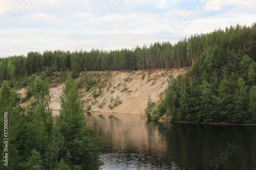 Palieozerskaya hydroelectric power plant and Suna river in Hirvas, Karelia region, Russia). Hydroelectric dam, reservoir, powerhouse, waterway, spillway gates. Girvas beautiful scandinavian landscape photo