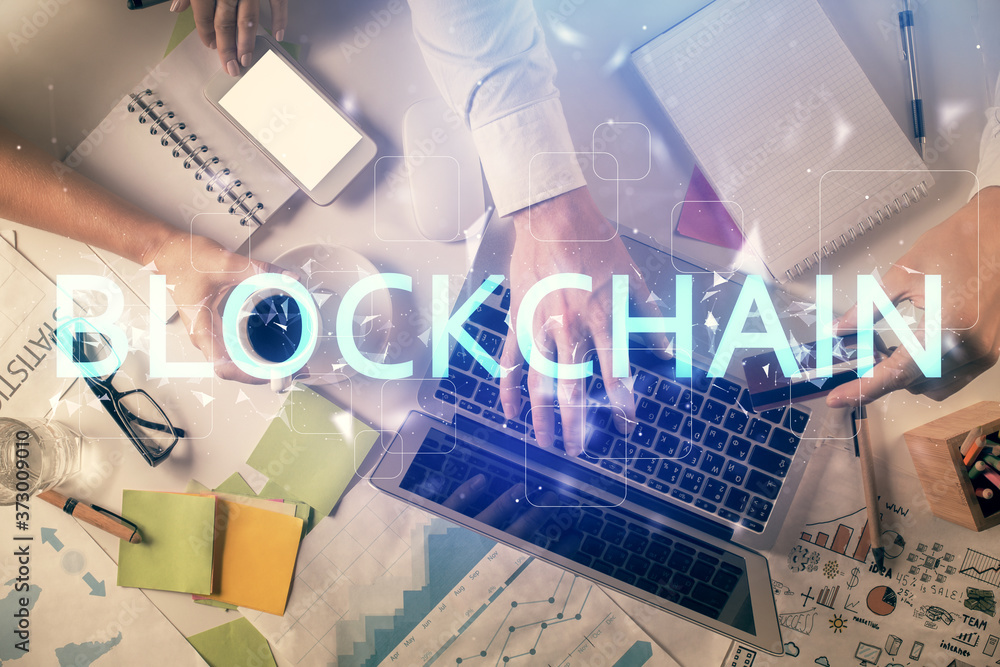 Double exposure of man and woman working together and crypto theme hologram drawing. Computer background. Blockchain concept. Top View. Double exposure of man and woman working together and crypto theme hologram drawing. Computer background. Blockchain concept. Top View.