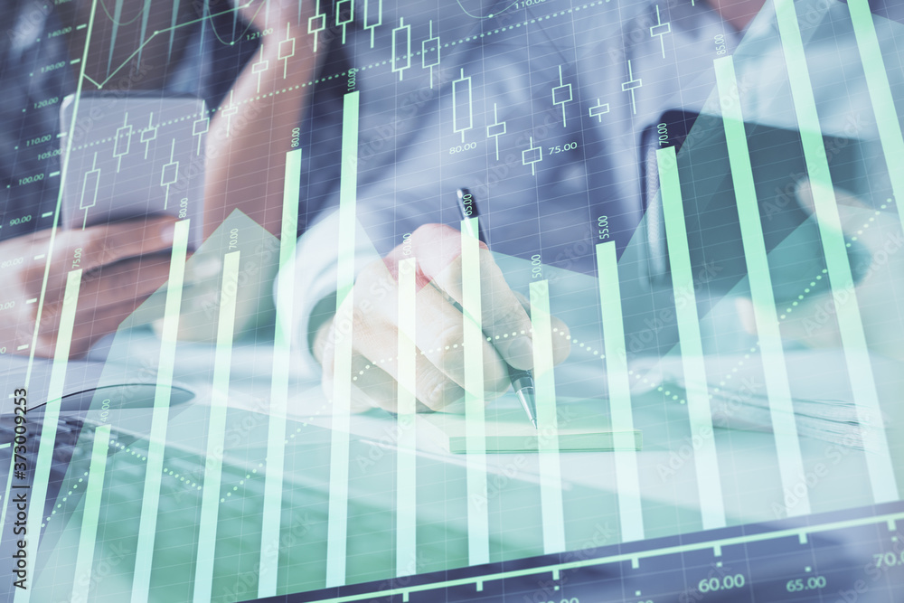 Double exposure of man and woman working together and financial graph hologram. Business concept. Computer background. Double exposure of man and woman working together and financial graph hologram. Business concept. Computer background.