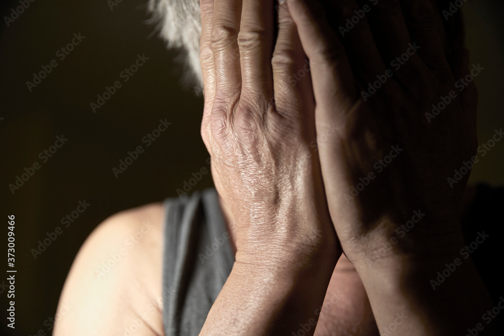 Man covering his face with his hands