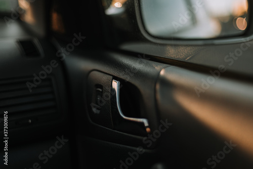 Car door handle, black interrior, metal handle design © Haris