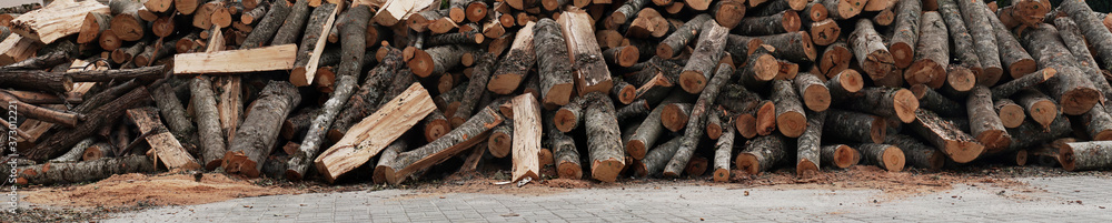 Wooden logs background. Stacked Firewood. Wood chips. Pile of chopped firewood. Hi Res banner. Wooden logs background. Stacked Firewood. Wood chips. Pile of chopped firewood. Hi Res banner.