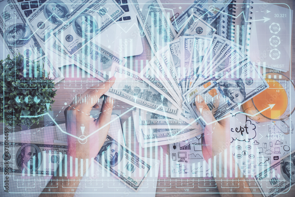 Multi exposure of financial graph drawing hologram and USA dollars bills and man hands. Analysis concept. Multi exposure of financial graph drawing hologram and USA dollars bills and man hands. Analysis concept.