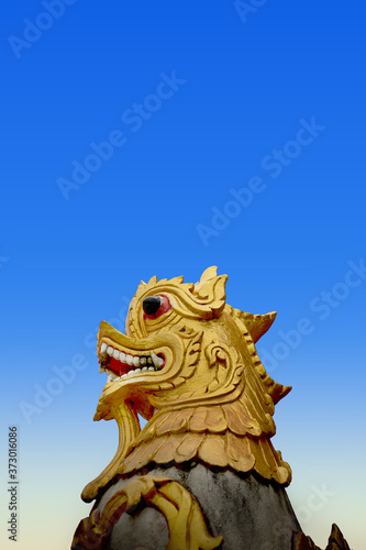 Beautiful golden lion sculpture with blue sky Located along the cliff on the mountain in Phra That Doi Kong Mu Temple at northern Thailand