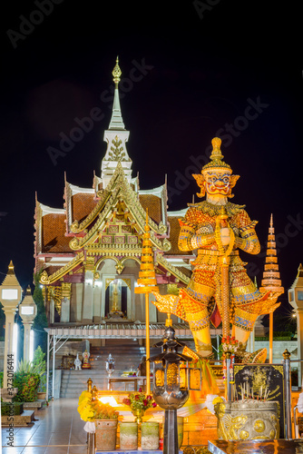 Thai Giant Statue in front of Pillar Shrine in Udon thani province,Thailand,Nightime. They are public domain or treasure of Buddhism, no restrict in copy of use.
