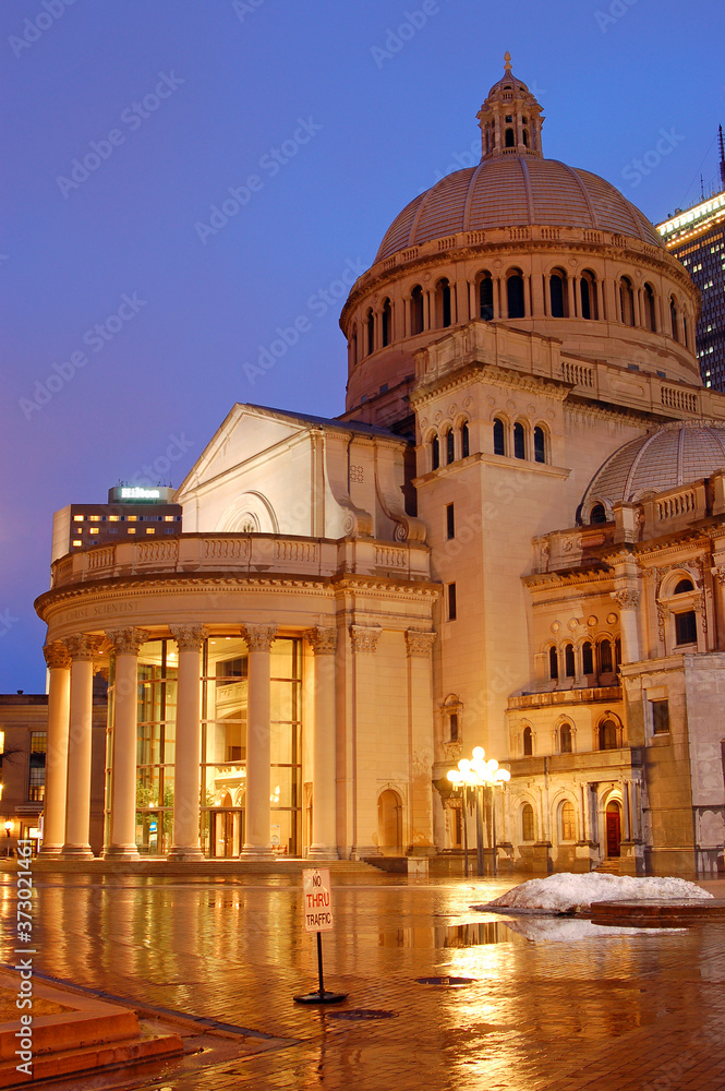 The Christian Science church is reflected in the rainy plaza in Boston