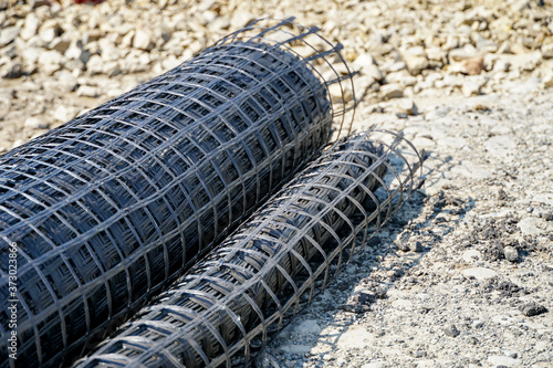 geogrid rolled into a roll, material for road surface repair
