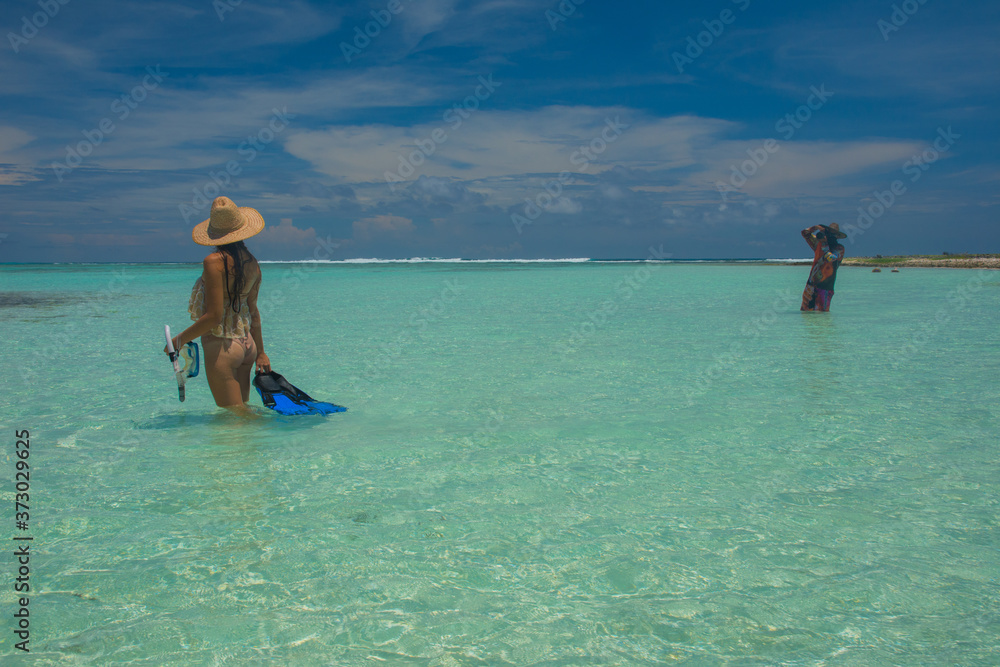woman Model posing to photographer with snorkel gear in paradise island at caribbean sea woman Model posing to photographer with snorkel gear in paradise island at caribbean sea