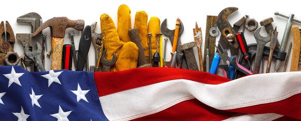 Patriotic collection of worn and used work tools with US American flag. Made in USA, American workforce, or Labor Day concept.