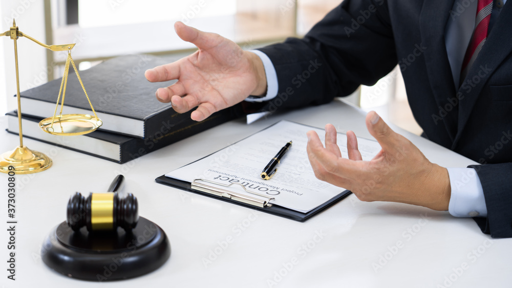 Client with his partner lawyers or attorneys discussing discussing a document or contract agreement working at table in office, Good service cooperation. Client with his partner lawyers or attorneys discussing discussing a document or contract agreement working at table in office, Good service cooperation.