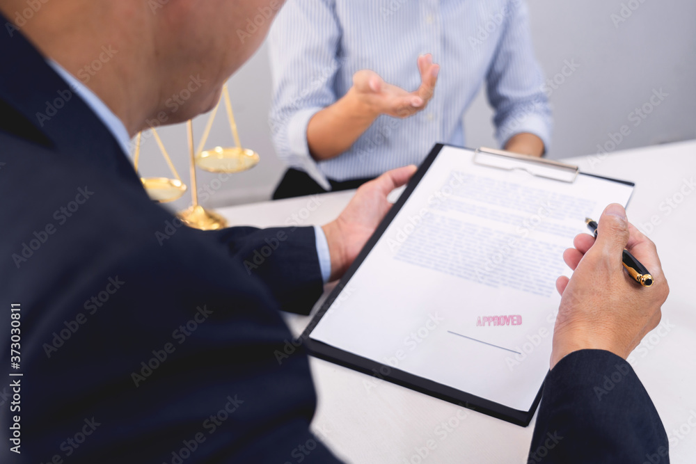 Client with his partner lawyers or attorneys discussing discussing a document or contract agreement working at table in office, Good service cooperation. Client with his partner lawyers or attorneys discussing discussing a document or contract agreement working at table in office, Good service cooperation.