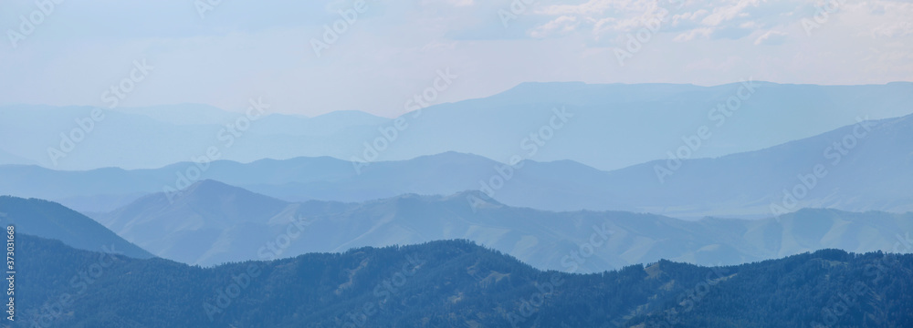 Mountains in the morning haze, blue natural background