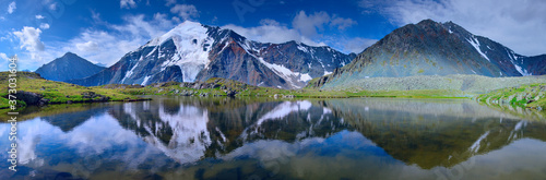 Lake in a mountain valley, beautiful reflection. Panorama nature, Altai.