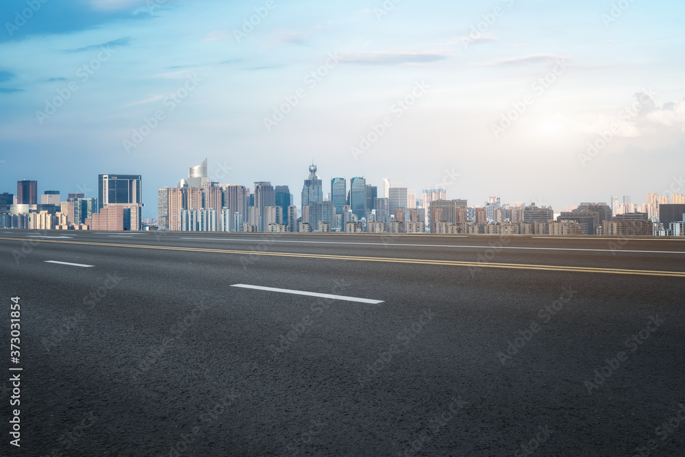 Empty asphalt road along modern commercial buildings in China, s cities