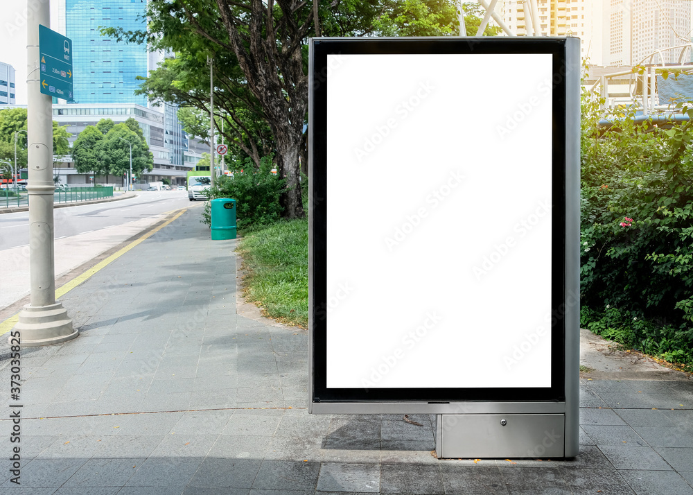 Billboard mock up in suburb background beautiful sunshine. Template of an empty information billboard near roadside with clear road, Mock-up of a city banner placeholder and poster. Billboard mock up in suburb background beautiful sunshine. Template of an empty information billboard near roadside with clear road, Mock-up of a city banner placeholder and poster.