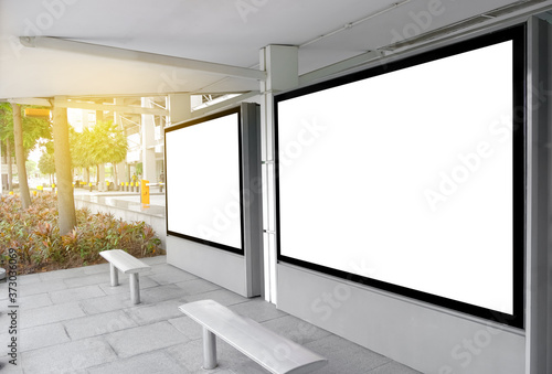 Billboard mock up in city background beautiful sunshine. Template of an empty information billboard near the stop of public transport, Mock-up of a city banner placeholder and poster.